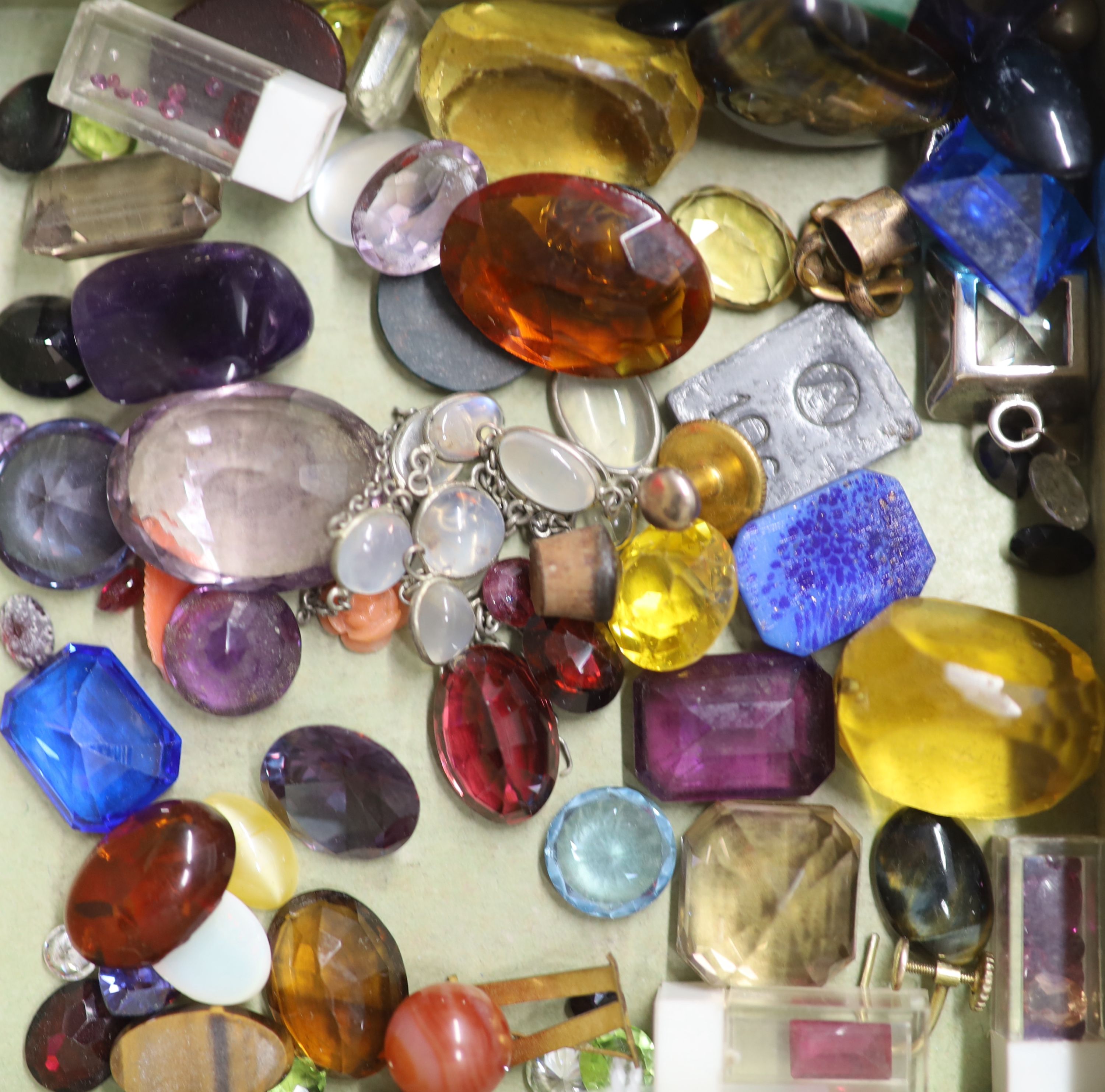 A quantity of assorted loose cut and cabochon gemstones including amethyst, citrine, opal and tourmaline.